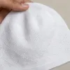 White knitted Muslim topi with a raised diamond pattern